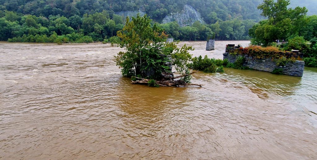 Looking towards the Shenandoah River with fast flowing flood water. Also in the photo is the old bridge supports of a bridge which was washed away in a flood.